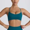 Bezszwowy biustonosz sportowy Super Sculpt z krzyżującymi się na plecach ramiączkami w kolorze turkusowym Bezszwowy biustonosz sportowy Super Sculpt z krzyżującymi się na plecach ramiączkami w kolorze turkusowym
