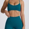 Bezszwowy biustonosz sportowy Super Sculpt z krzyżującymi się na plecach ramiączkami w kolorze turkusowym Bezszwowy biustonosz sportowy Super Sculpt z krzyżującymi się na plecach ramiączkami w kolorze turkusowym