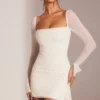 Biała mini sukienka Ferrara z długim rękawem i ozdobnym dekoltem typu cowl Biała mini sukienka Ferrara z długim rękawem i ozdobnym dekoltem typu cowl