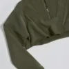 Krótka bluza z bawełnianej dzianiny z efektem sprania kwasem w kolorze jasnozielonym Krótka bluza z bawełnianej dzianiny z efektem sprania kwasem w kolorze jasnozielonym