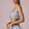 Krótki top Ottilie z falbanami i wiązaniem z przodu w kolorze pudrowego błękitu Krótki top Ottilie z falbanami i wiązaniem z przodu w kolorze pudrowego błękitu