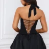 Ludmila – mikro mini sukienka z gorsetem, wiązaniem na szyi i falbanowym dołem w kolorze czarnym Ludmila – mikro mini sukienka z gorsetem, wiązaniem na szyi i falbanowym dołem w kolorze czarnym