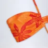 Stroje jednoczęściowe Maranta z wycięciami i wiązaniem na szyi w pomarańczowo-orchideowym wzorze Stroje jednoczęściowe Maranta z wycięciami i wiązaniem na szyi w pomarańczowo-orchideowym wzorze