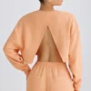 Teksturowana bawełniana bluza z odkrytymi plecami w kolorze brzoskwiniowym Teksturowana bawełniana bluza z odkrytymi plecami w kolorze brzoskwiniowym