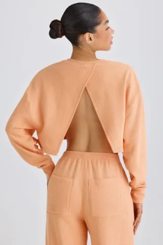Teksturowana bawełniana bluza z odkrytymi plecami w kolorze brzoskwiniowym