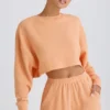 Teksturowana bawełniana bluza z odkrytymi plecami w kolorze brzoskwiniowym Teksturowana bawełniana bluza z odkrytymi plecami w kolorze brzoskwiniowym