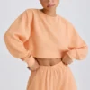 Teksturowana bawełniana bluza z odkrytymi plecami w kolorze brzoskwiniowym Teksturowana bawełniana bluza z odkrytymi plecami w kolorze brzoskwiniowym