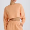 Teksturowana bawełniana bluza z odkrytymi plecami w kolorze brzoskwiniowym Teksturowana bawełniana bluza z odkrytymi plecami w kolorze brzoskwiniowym